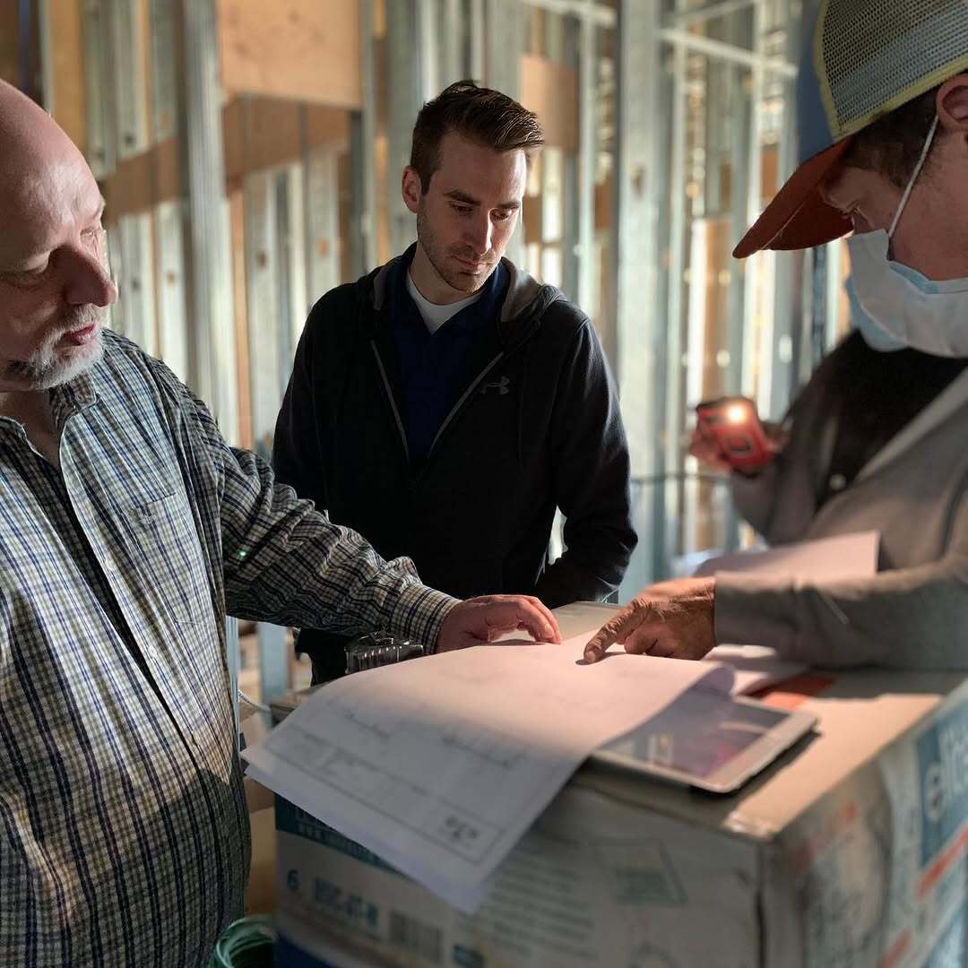 Reviewing blueprints on a construction site